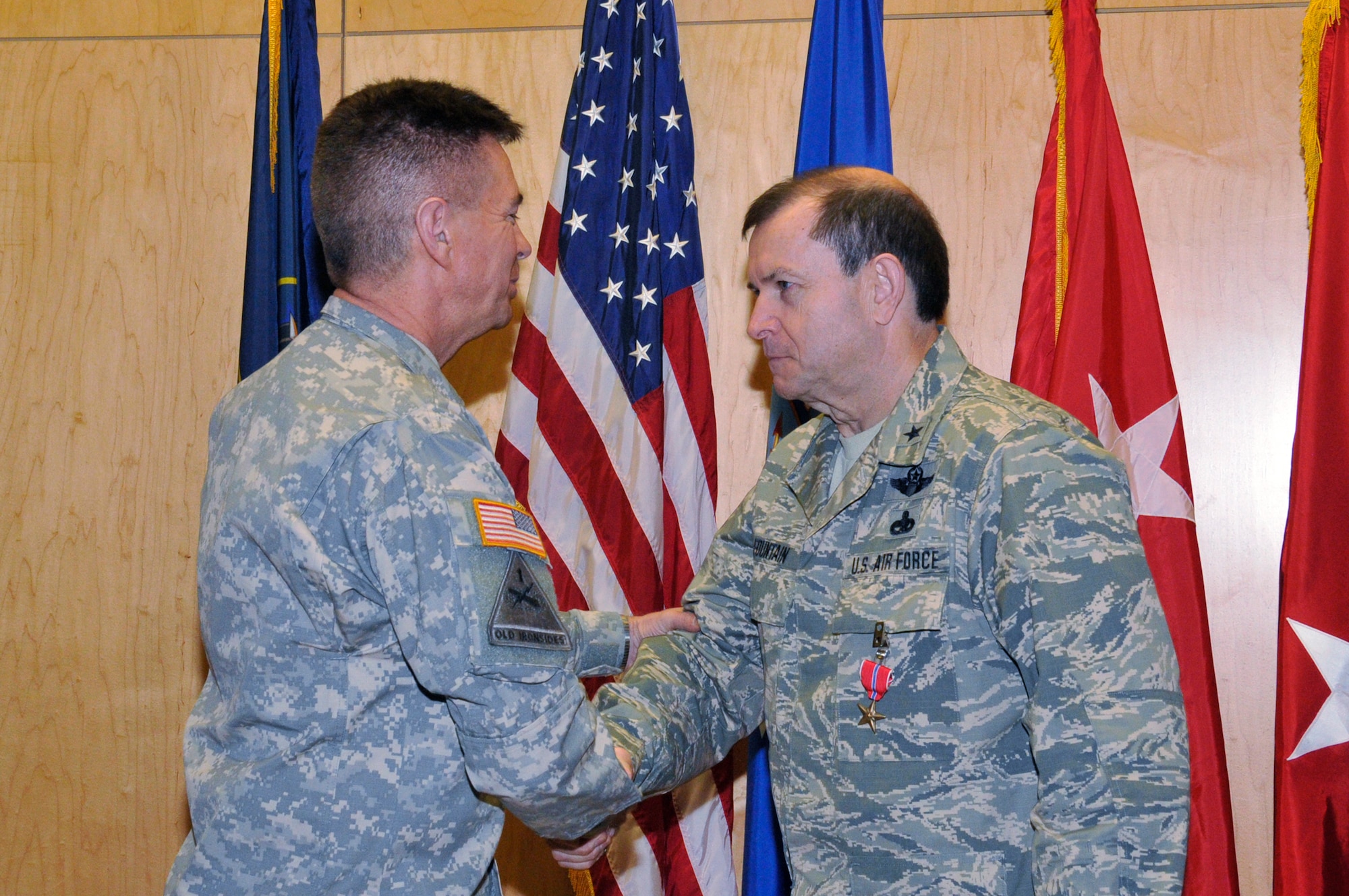 Maj. Gen. Jefferson S. Burton, Adjutant General of the Utah National guard, presents a Bronze Star Medal to Brig. Gen. David R. Fountain, the Assistant Adjutant General for Air, Joint Task Force Headquarters, Utah Air National Guard, on January 11, 2014.  Fountain received the award for meritorious achievement during his deployment in support of Operation Enduring Freedom from March 28, 2013 to January 8, 2014. (Utah National Guard Photo by SSgt Annie Edwards/Released)