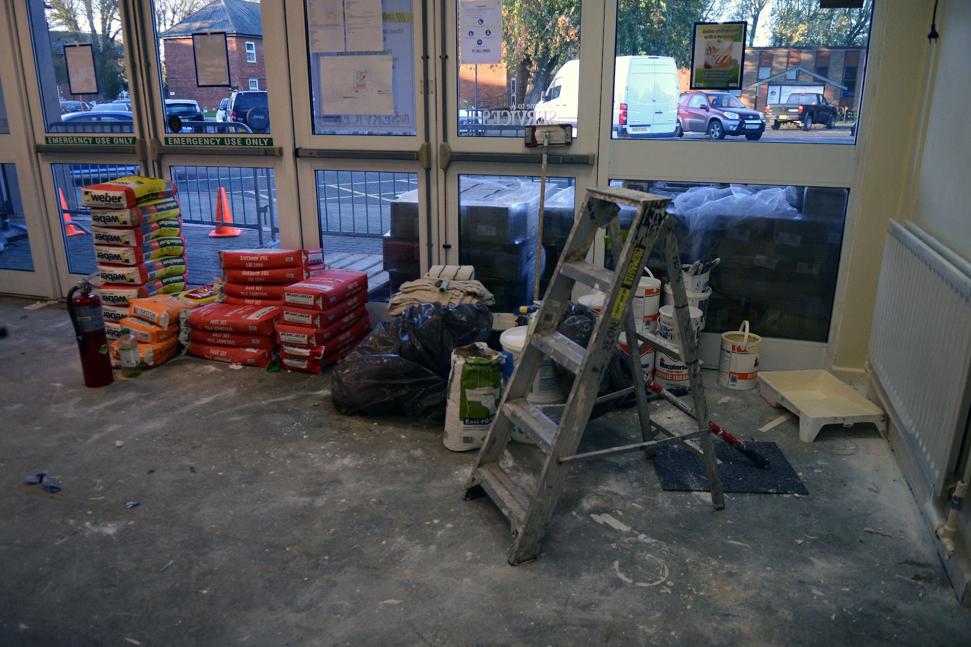 Contractors renovate the entrance to the Northside Fitness Center Nov. 4. 2013, on RAF Mildenhall, England. The fitness center has been closed to add fresh paint and new tile flooring to the interior of the facility. (U.S. Air Force photo by Airman 1st Class Kyla Gifford/Released)