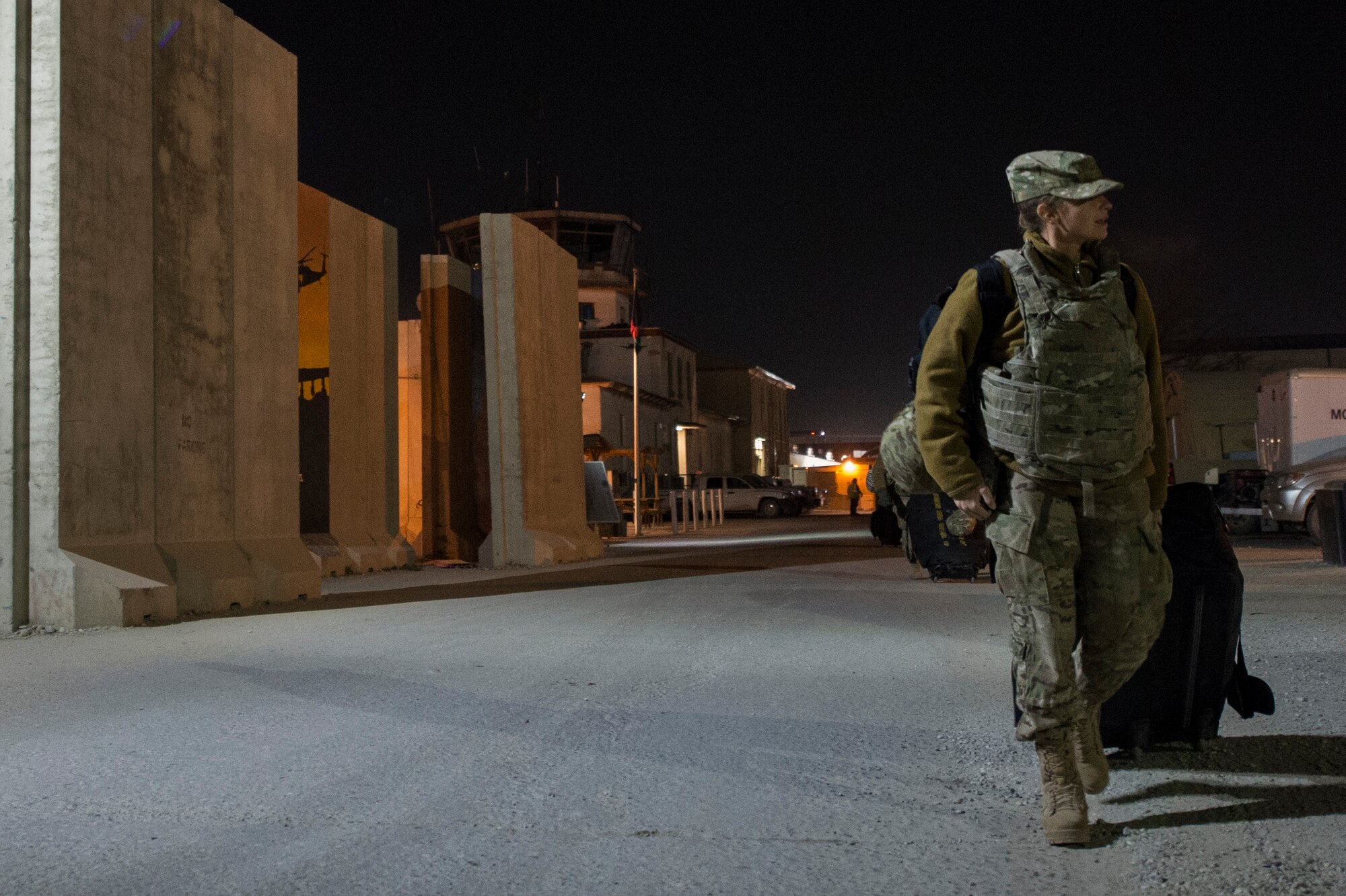 U.S. Air Force Staff. Sgt. Kelly Perry, Air Forces Central Command Band vocalist, moves her personnel luggage to the passengers terminal to travel from Bagram Air Field to Forward Operating Base Fenty, Afghanistan, Dec. 23, 2013. The AFCENT band performed at various locations around Bagram Airfield during their 15 day tour of Afghanistan. Perry a Crestwood, Ky., native, is deployed from the Air Force Band of Flight, Wright Patterson, Air Force Base, Ohio. (U.S. Air Force photo by Tech. Sgt. Jason Robertson/released)
