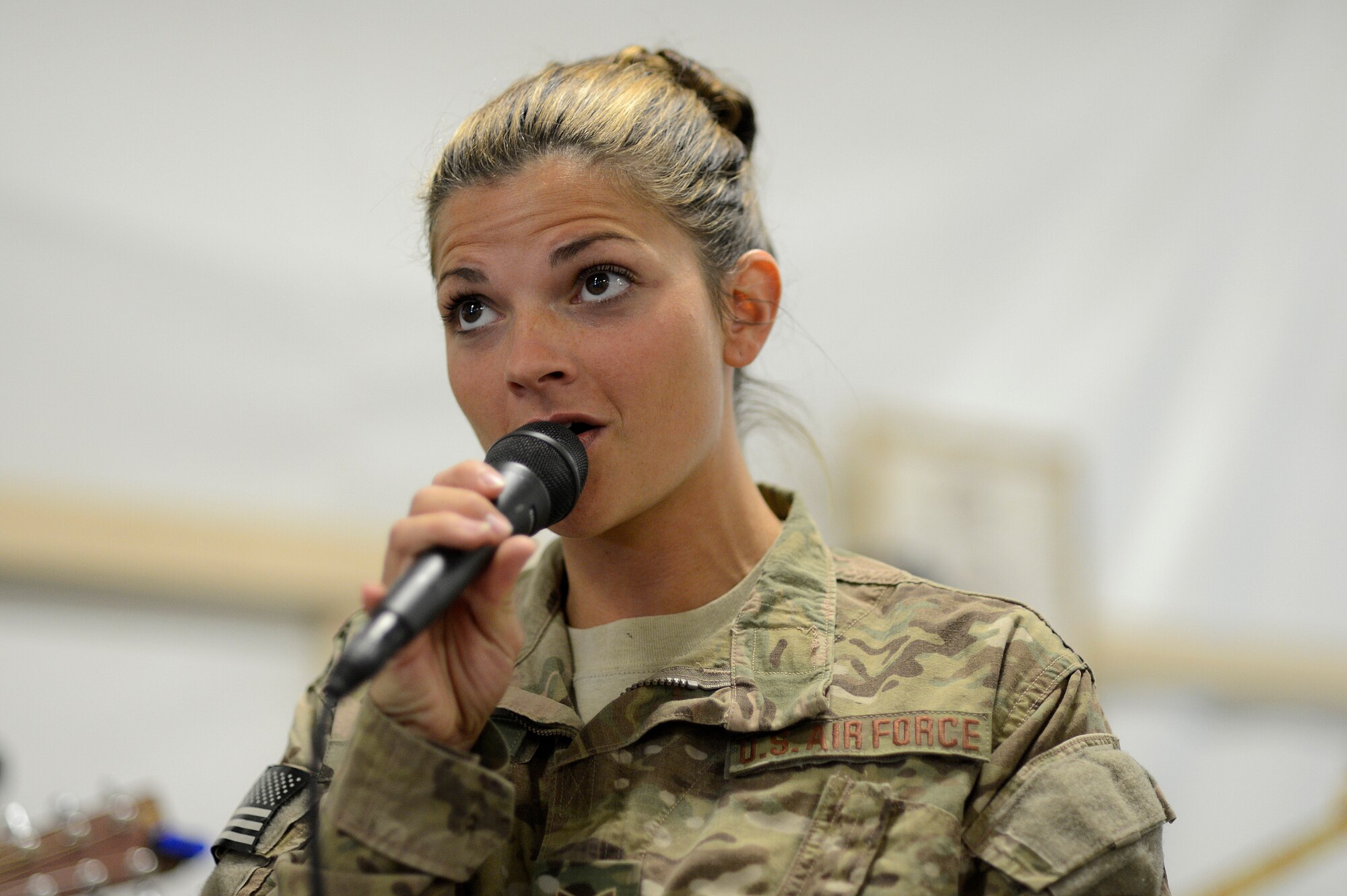 U.S. Air Force Staff. Sgt. Kelly Perry, Air Force Central Command Band vocalist, entertains a crowd of service members during a dining facility performance Dec. 18, 2013, at Camp Leatherneck, Afghanistan. Camp Leatherneck is the second stop on the band's tour of Afghanistan. Perry a Crestwood, Ky., native, is deployed from the Air Force Band of Flight, Wright Patterson, Air Force Base, Ohio. (U.S. Air Force photo by Tech. Sgt. Jason Robertson/released)