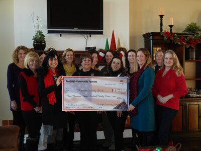 Randolph Community Spouses’ Joint Base San Antonio-Randolph members hold a check for $ 3,727 Jan. 7 at JBSA-Randolph. The money was collected from ticket costs and donations during the Holliday Tour of Homes event Dec. 2, 2013. The money will go to the Wounded Warrior Family Fund, which is used for programs and events that support the families of the deployed service members. (Courtesy photo)