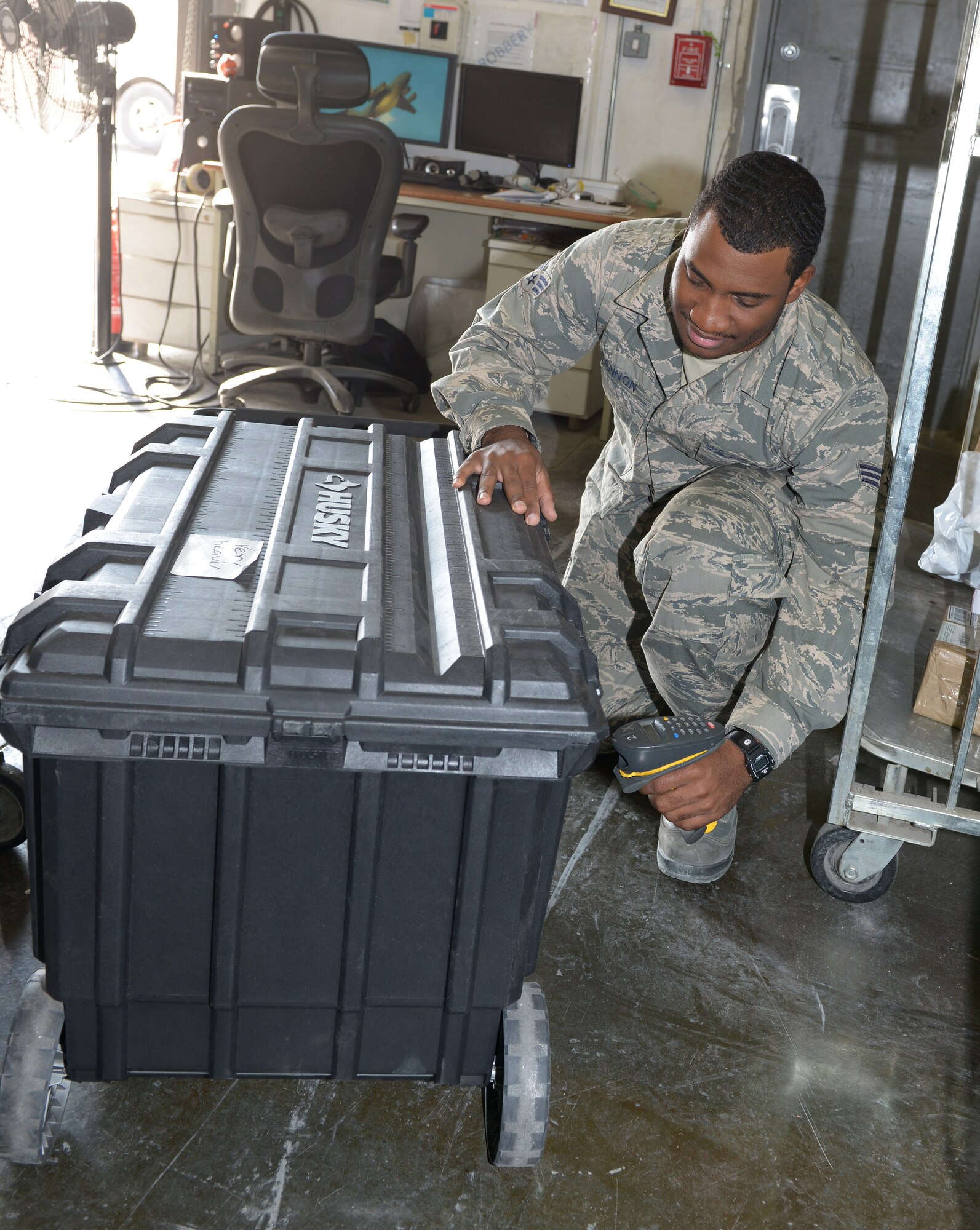 Senior Airman Cordero Cannon, 379th Expeditionary Communications Squadron postal specialist, scans a case during an inventory check at Al Udeid Air Base, Qatar, Jan. 8, 2014. The post office employs 16 Airmen and processes nearly 866 packages and letters of incoming and outgoing mail each day. Inventory is taken daily of all incoming and outgoing products to ensure the mail reaches the correct destination and isn’t misplaced.  Cannon is an Americus, Ga., native deployed from Mainz-Kastel, Germany. (U.S. Air Force photo/Senior Airman Hannah Landeros) 
