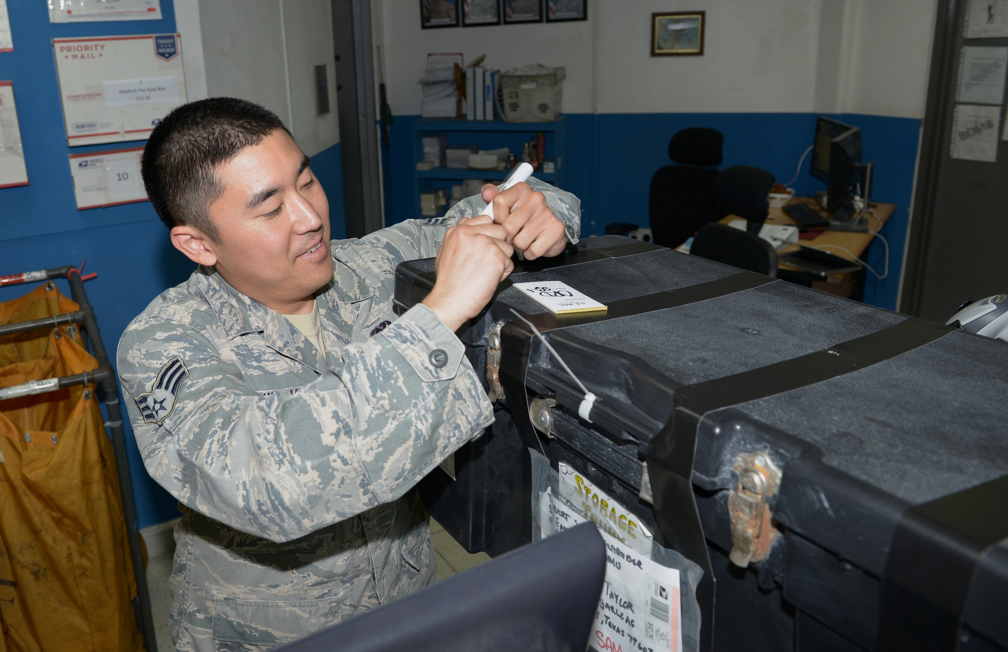Senior Airman David Umeno, 379th Expeditionary Communications Squadron postal specialist, takes inventory of a storage trunk being shipped back to the United States from Al Udeid Air Base, Qatar, Jan. 8, 2014. Inventory is taken daily of all incoming and outgoing packages to ensure the mail reaches the correct destination and isn’t misplaced. The post office employs 16 Airmen and processes nearly 866 packages and letters of incoming and outgoing mail each day. Umeno is an Kailua-Kona, Hawaii, native deployed from Ramstein, Germany. (U.S. Air Force photo/Senior Airman Hannah Landeros) 