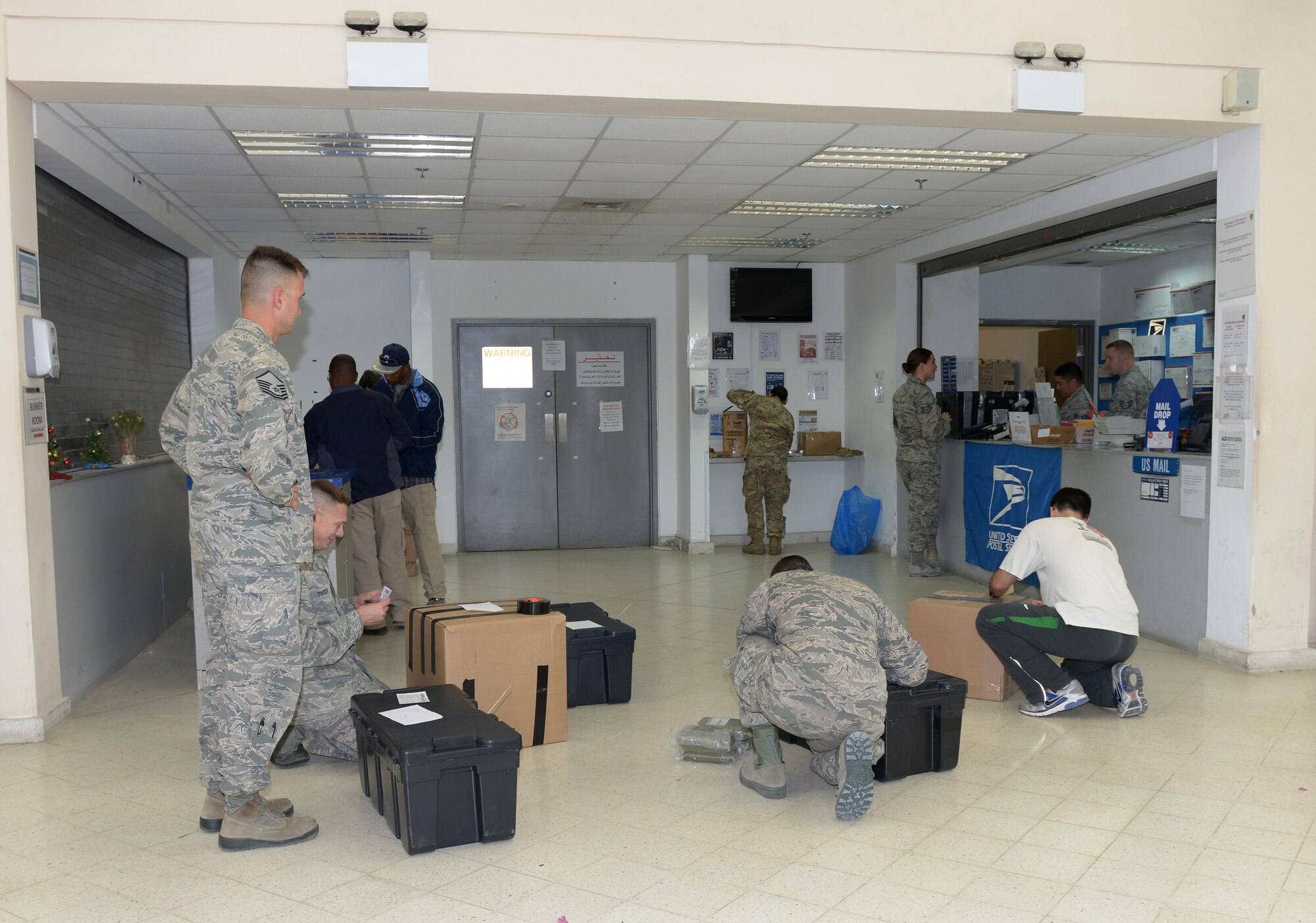 Deployed Airmen at Al Udeid Air Base, Qatar, prepare to ship packages back to the United States Jan. 8, 2014. The post office employs 16 Airmen and processes nearly 280 packages of incoming mail and nearly 500 letters and 86 packages of outgoing mail a day. The 379th Communications Squadron post office takes inventory daily to ensure the mail reaches the correct destination and isn’t misplaced. (U.S. Air Force photo/Senior Airman Hannah Landeros)