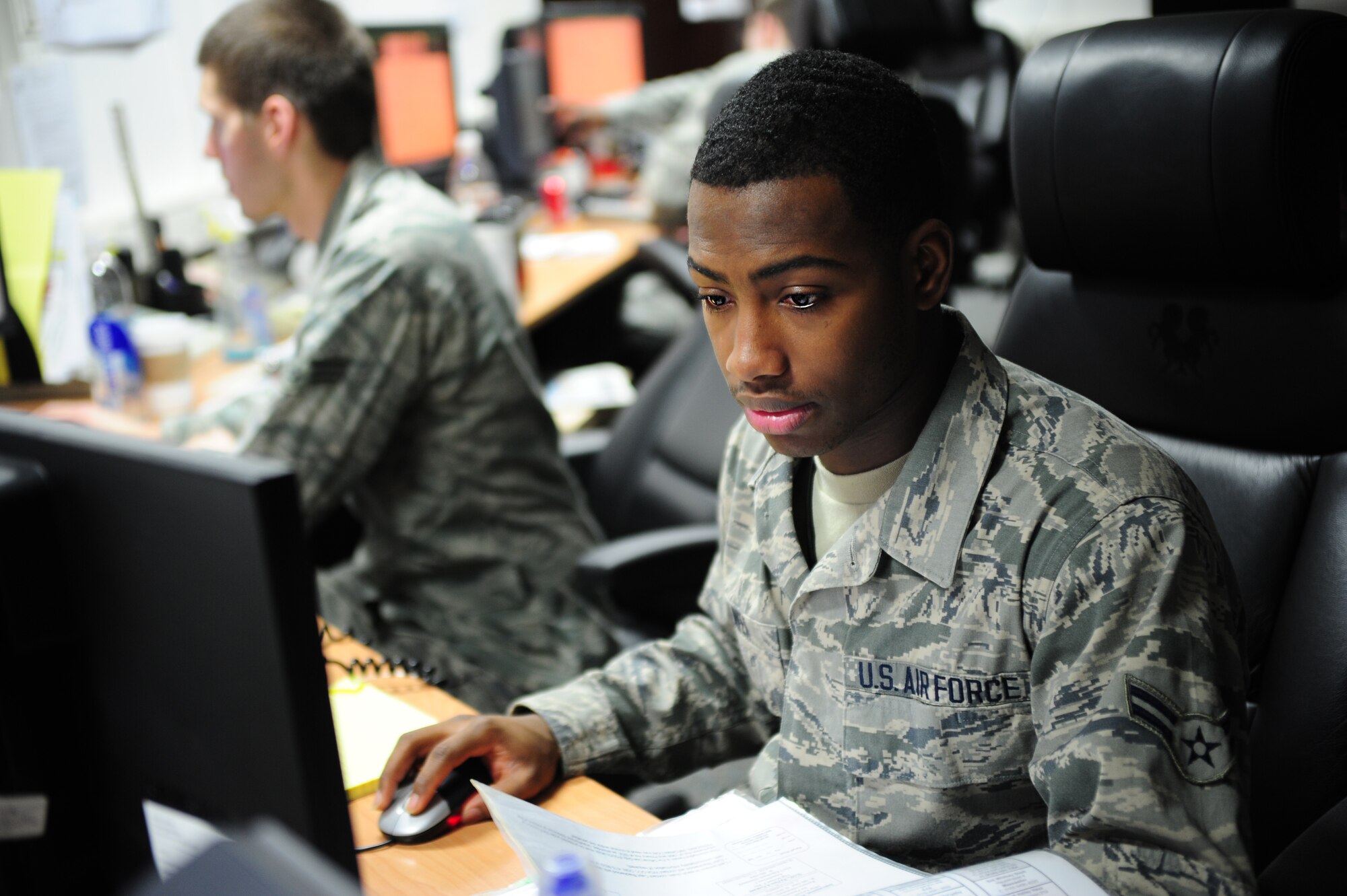 Airman 1st Class David Weaver, 86th Airlift Wing Command Post emergency actions controller, tracks current operations, Jan. 10, 2014, Ramstein Air Base, Germany. Airmen in the command post are tested monthly to complete certifications and demonstrate their ability to perform in emergency and non-emergent situations. (U.S. Air Force photo/Senior Airman Hailey Haux)