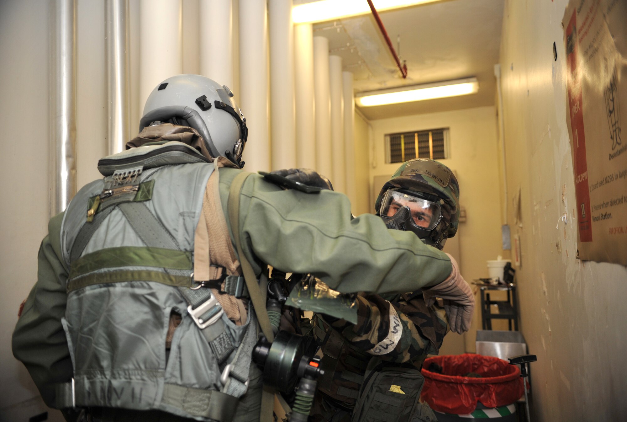 A member of the 51st Operations Support Squadron Aircrew Flight Equipment section uses M-295 pads to “decontaminate” the flight suit of Capt. William Yoakley, 25th Fighter Squadron A-10 Thunderbolt II pilot, during Operational Readiness Exercise Beverly Midnight 14-01 at Osan Air Base, Republic of Korea, Jan. 15, 2014. Yoakley was one of several pilots who participated in a training scenario to practice donning chemical, biological, radiological and nuclear threat protection flight gear. (U.S. Air Force photo/Airman 1st Class Ashley J. Thum)