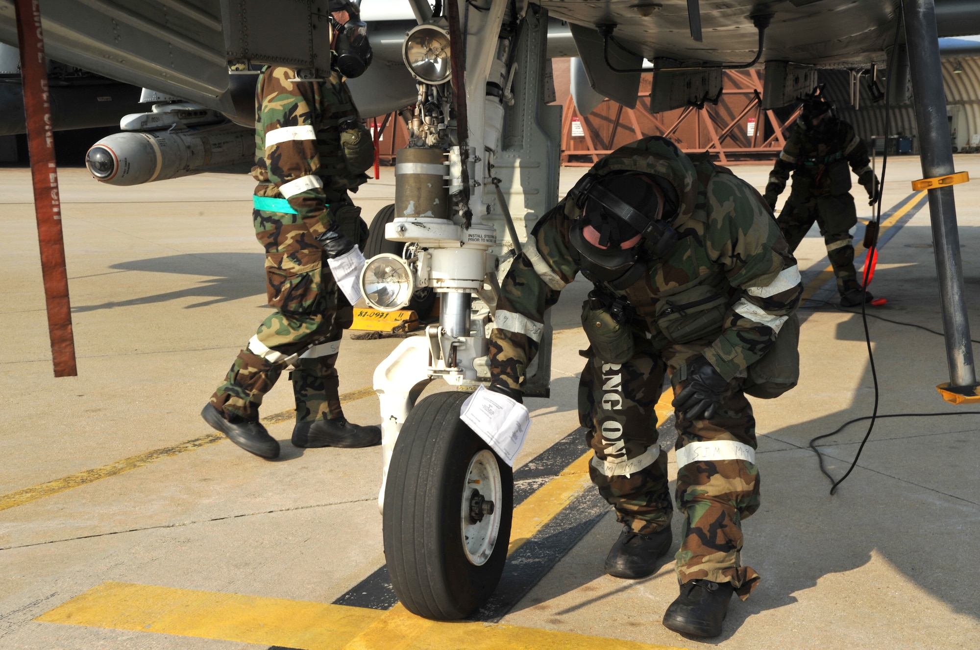 Airmen from the 51st Aircraft Maintenance Squadron “decontaminate” an A-10 Thunderbolt II during a training scenario as part of Operational Readiness Exercise Beverly Midnight 14-01 at Osan Air Base, Republic of Korea, Jan. 15, 2014. If an aircraft was exposed to a chemical, biological, radiological or nuclear contaminant in a real-world operation, the surface must be wiped down to create a clean path for the pilot to exit the plane. (U.S. Air Force photo/Airman 1st Class Ashley J. Thum)