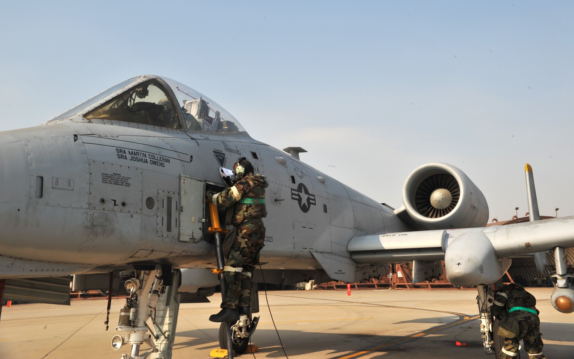 Senior Airman Alexandria Ketterhagen, 51st Aircraft Maintenance Squadron crew chief, clears a path free of mock chemical, biological, radiological or nuclear contaminants during a training scenario as part of Operational Readiness Exercise Beverly Midnight 14-01 at Osan Air Base, Republic of Korea, Jan. 15, 2014. The drill required Airmen from the 51st AMXS to treat the aircraft as if it had been contaminated in a CBRN environment. (U.S. Air Force photo/Airman 1st Class Ashley J. Thum)