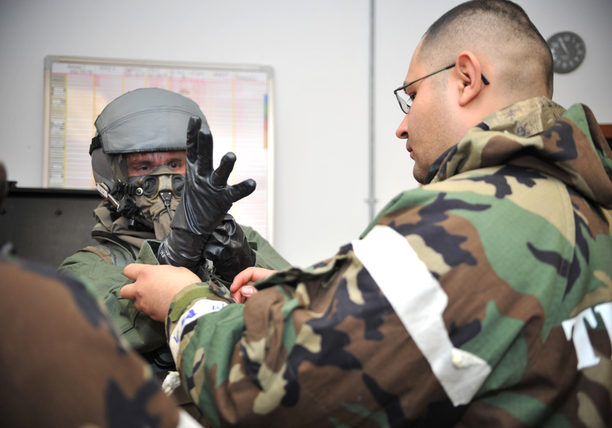 A 25th Fighter Squadron A-10 Thunderbolt II pilot is fitted with chemical, biological, radiological and nuclear threat protection flight gear by a member of the 51st Operations Support Squadron Aircrew Flight Equipment section during a training scenario as part of Operational Readiness Exercise Beverly Midnight 14-01 at Osan Air Base, Republic of Korea, Jan. 15, 2014. The pilot in the scenario donned Mission Oriented Protective Posture Level 2 gear specifically designed for flight. (U.S. Air Force photo/Airman 1st Class Ashley J. Thum)