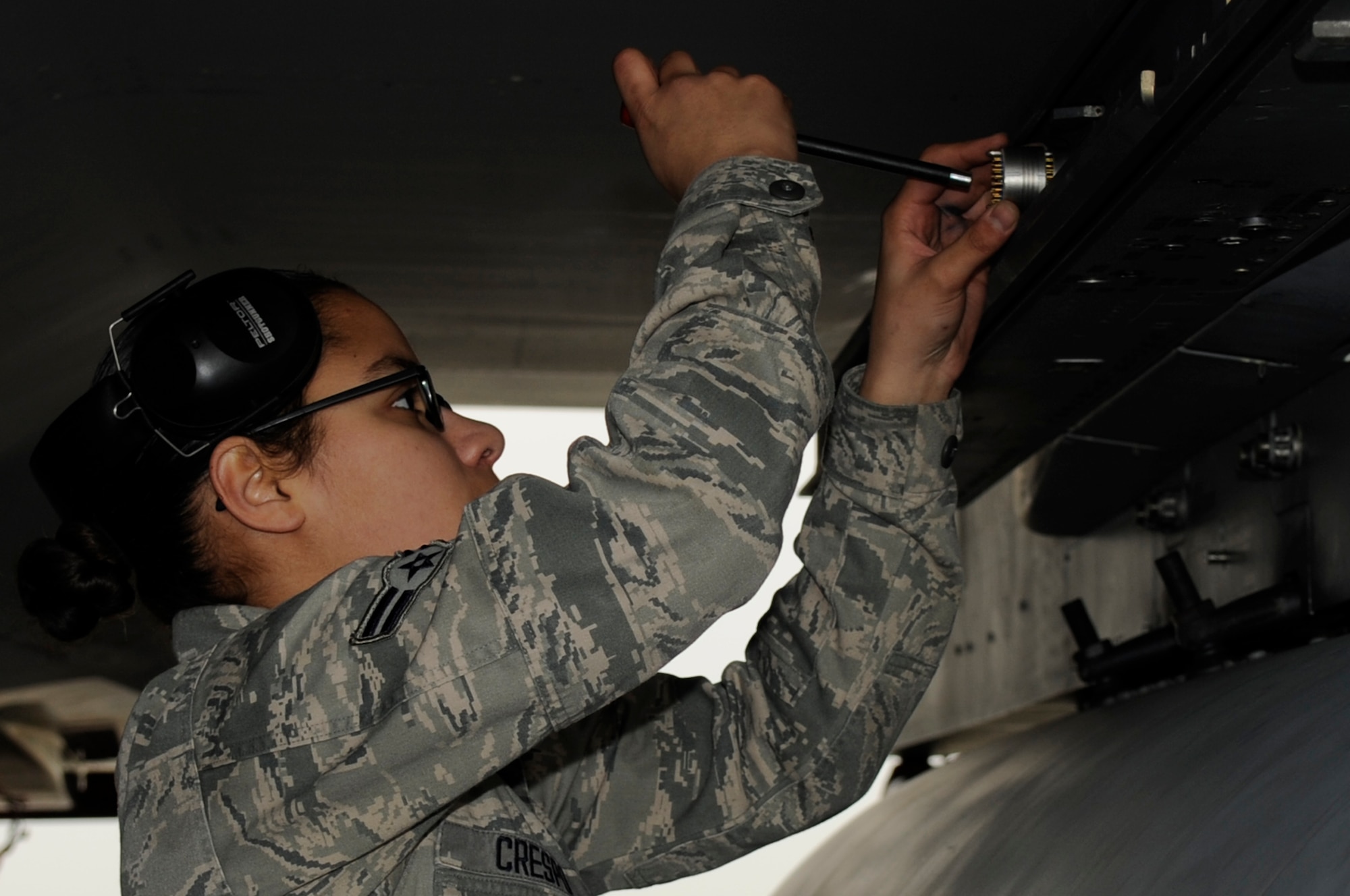 U.S. Air Force Airman 1st Class Frances Crespo, 67th Aircraft Maintenance Unit weapons load crew member, prepares an F-15 Eagle to be equipped with missiles during a weapons load competition on Kadena Air Base, Japan, Jan. 13, 2014. Competitions allow load crews to compete against each other and demonstrate their skills to other organizations. (U.S. Air Force photo by Senior Airman Marcus Morris)  

