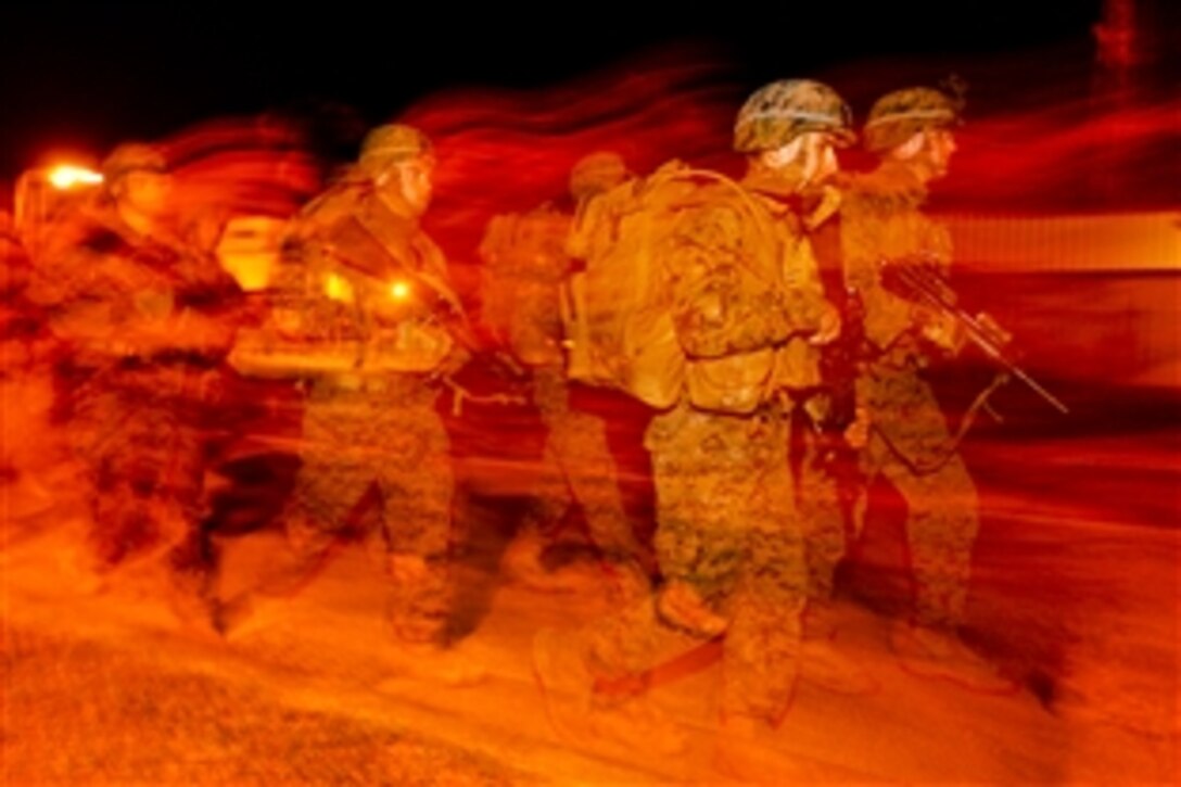 U.S. Marines quickly move to their first event in a squad competition on Camp Hansen, Okinawa, Japan, Jan. 11, 2014. Nine squads competed in events to test physical endurance, hand-to-hand combat, teamwork and knowledge. The 31st Marine Expeditionary Unit is the Marine Corps’ force in readiness in the Asia-Pacific region.