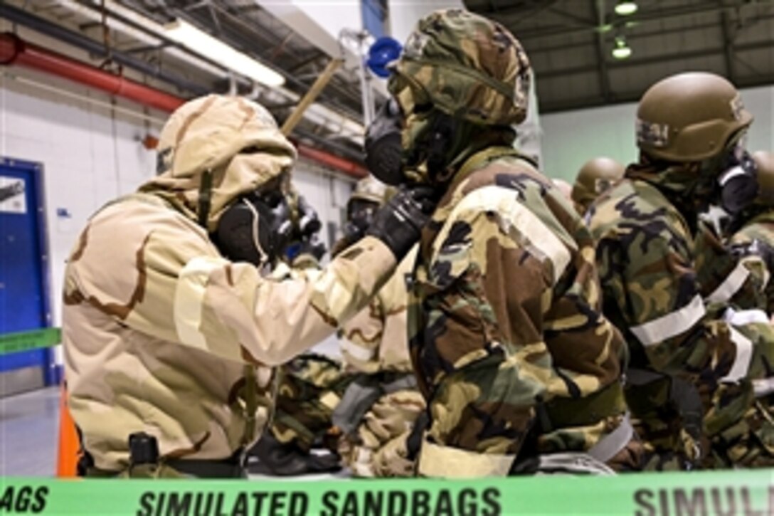 Airmen react to a simulated alarm red signal during survival training on Warfield Air National Guard Base in Baltimore, Md., Jan. 11, 2014. The airmen are assigned to the 175th Aircraft Maintenance Squadron.