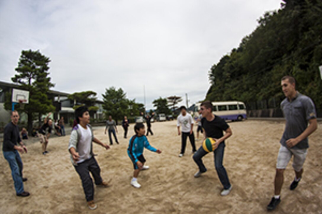 Volunteers from Marine Corps Air Station Iwakuni, Japan, play basketball with children from a Yamaguchi city children’s home during a Single Marine Program trip, Oct. 19, 2013. SMP trip participants spent the afternoon playing several sports and finding other ways to communicate with the children.