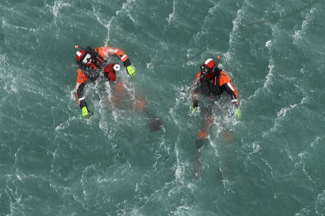 Cpl. Kyle Alessandro (left), and Sgt. Zachary Wood wait for the next evolution of training to begin off the coast of North Carolina Jan 9. Both Alessandro and Wood are search and rescue swimmers with Marine Transport Squadron 1.