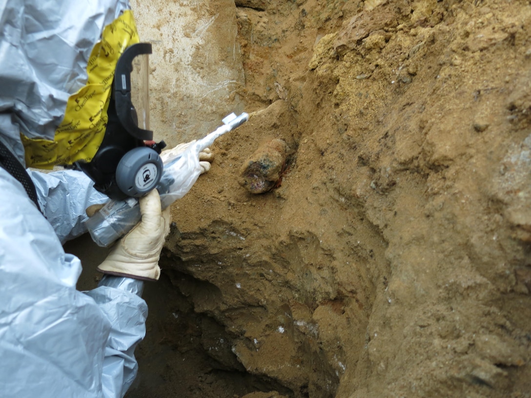 Dig team member is providing monitoring of the 75mm shrapnel round that was encountered at the site.  