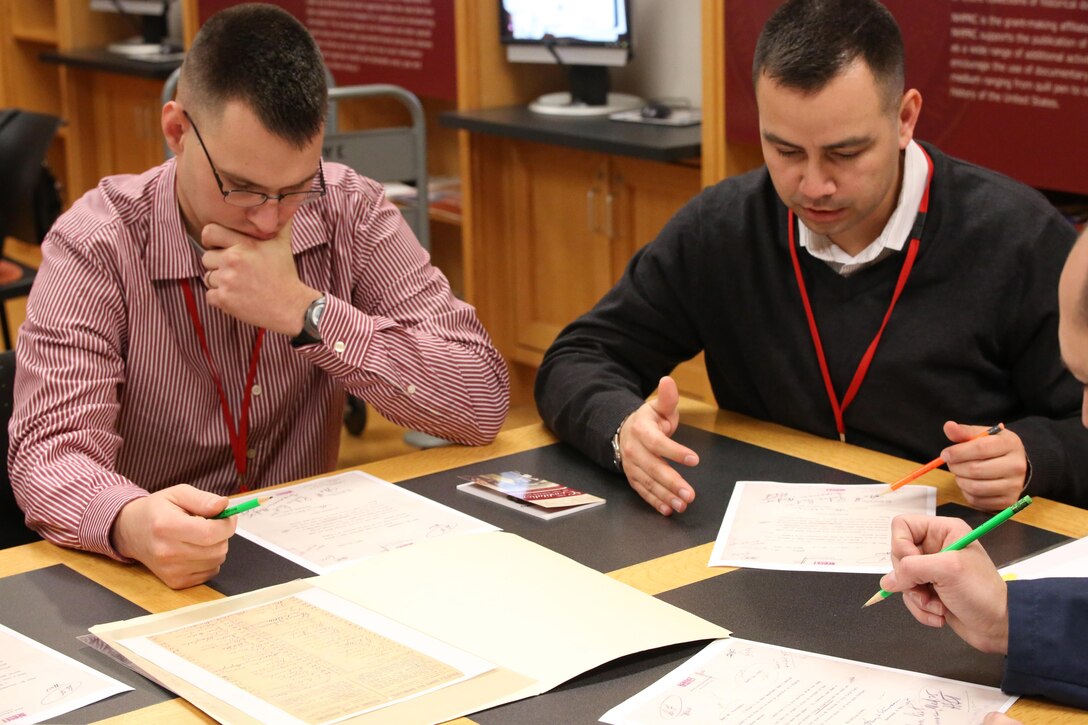 Captains Dimitri Stepanoff and Everett Stevenson, communications officers for the Marine Corps Communications School research a historical document to discover where the document was supported by the constitution Thursday Jan. 16, 2014, at the National Archives in Washington D.C. (Marine Corps photo by Lance Cpl. Cameron Storm)