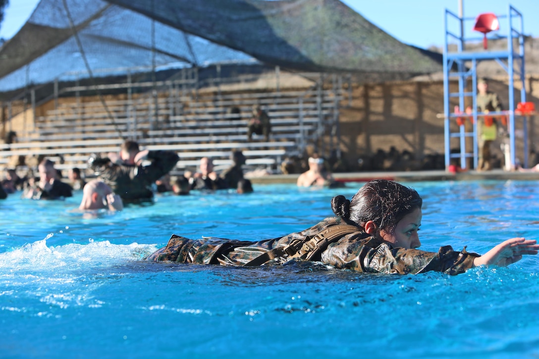 Corporal Priscilla Suarez, motor transportation operator, Alpha Company, 7th Engineer Support Battalion, 1st Marine Logistics Group, conducts the 25-meter swim during her annual swim qualification aboard Camp Pendleton, Calif., Jan. 13, 2014. During the training, Marines wore camouflage utilities while executing multiple tasks, including a 25-meter swim, jumping off a 25-foot tower, treading water for five minutes, and taking off a combat load while sub-surfaced. 