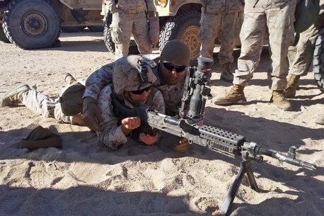 Lance Cpl. Dustin Luse, left, demonstrates how to operate the M240B with the help of Sgt. Joseph Lopez, right, both with Motor Transportation Company, Combat Logistics Battalion 5, Combat Logistics Regiment 1, 1st Marine Logistics Group, aboard Marine Air Ground Combat Center Twentynine Palms, Calif., Dec. 11, 2013. Luse, of Vidor, Texas, recently supported Exercise Steel Knight 2014. SK14 is an annual exercise designed to prepare the 1st Marine Division for deployment. 