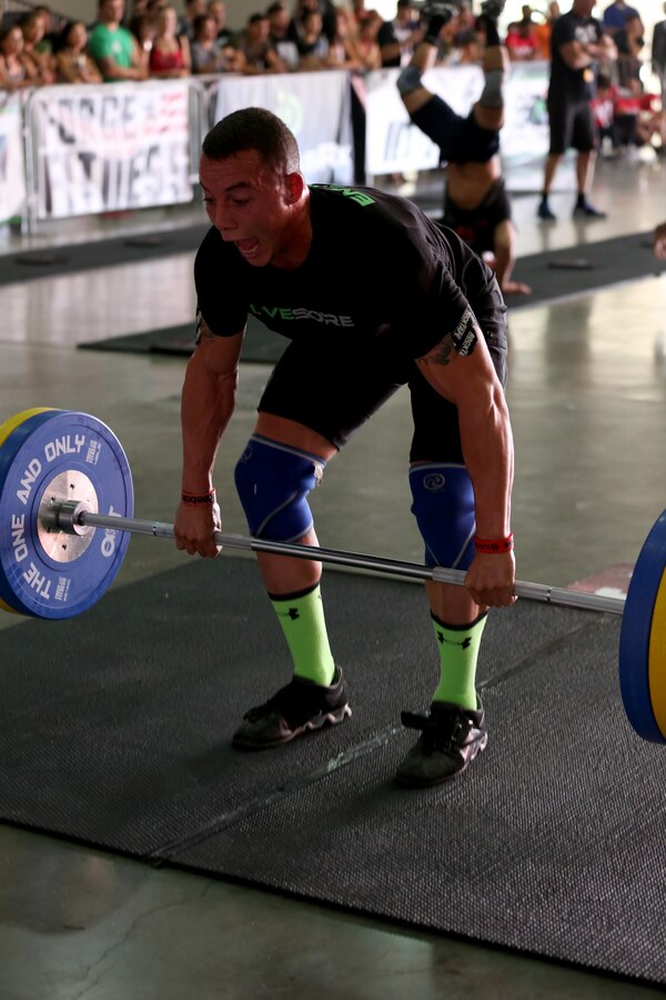 Sgt. Aaron Gardner, training clerk with Headquarters and Headquarters Squadron, Marine Corps Air Station Miramar, Calif., performs a squat clean during the second day of the Orange County Throwdown at the Orange County Fair Grounds, Jan. 11. Gardner dedicated himself to the sport he loves and trained for hours a day to compete against athletes who had either been to the CrossFit Games, or to regional qualifiers – CrossFit’s equivalent to the Super Bowl.