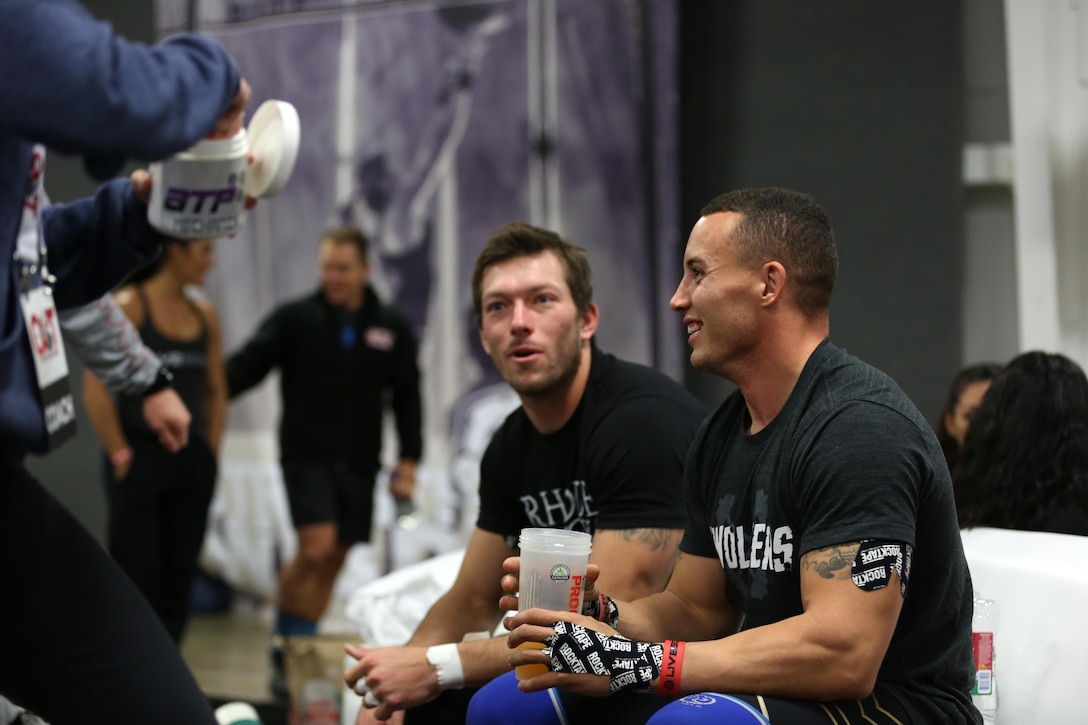 Sgt. Aaron Gardner, right, training clerk with Headquarters and Headquarters Squadron, Marine Corps Air Station Miramar, Calif., and teammate Wes Piatt, left, Coast Range CrossFit in Gilroy, Calif., enjoy a snack and some conversation while resting during Orange County Throwdown at the Orange County Fair Grounds, Jan. 11. Gardner realized a three year-old dream when he competed in the CrossFit competition, and gained the notice of CrossFit Games veterans like Piatt and several others by being a new face in the rapidly growing competition. 