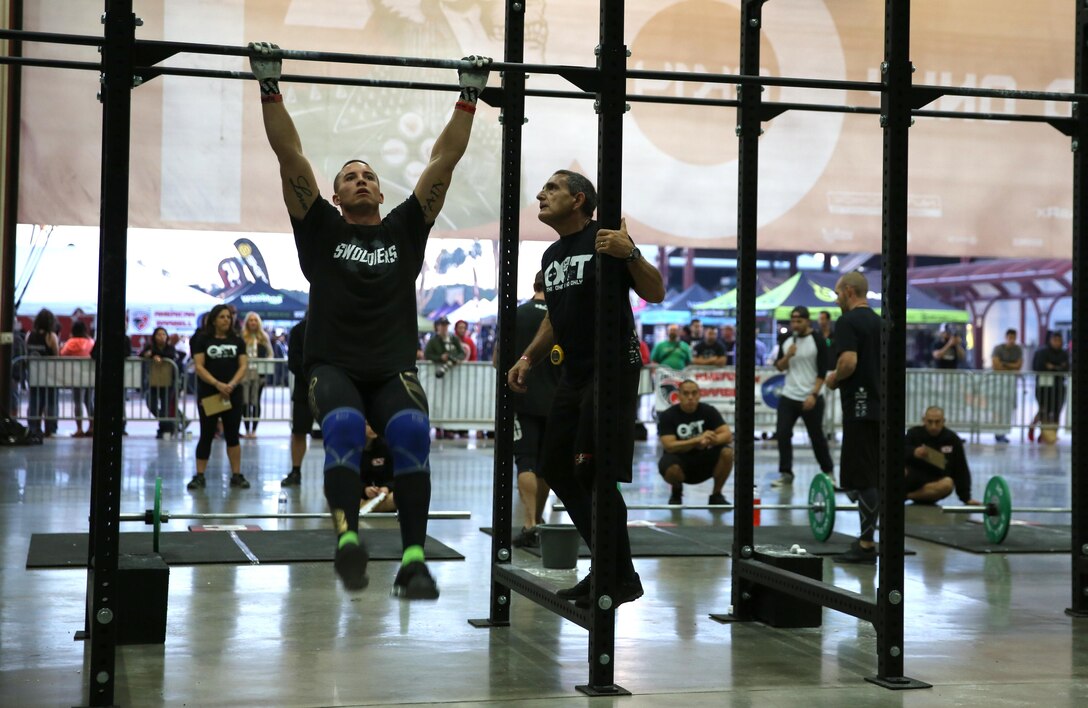 Sgt. Aaron Gardner, training clerk with Headquarters and Headquarters Squadron, Marine Corps Air Station Miramar, Calif., performs pull ups during the Orange County Throwdown at the Orange County Fair Grounds, Jan. 11. Gardner dedicated himself to the sport he loves and trained for hours a day to compete against athletes who had either been to the CrossFit Games, or to regional qualifiers – CrossFit’s equivalent to the Super Bowl.