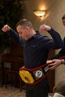 Staff Sgt. Brent Howard, from Recruiting Substation Appleton, receives the Championship Belt for RS Milwaukee’s Recruiter of the Year, Jan. 10, 2014.