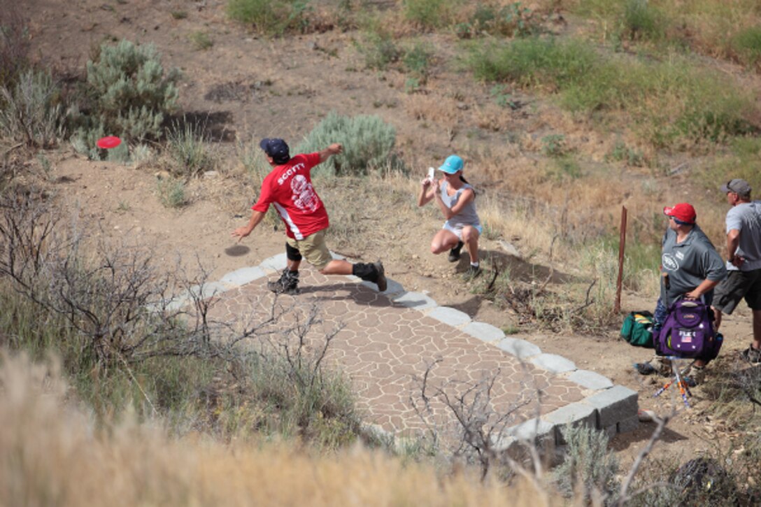 A group of disc golfers take their turns attempting an Ace on tee 7 of the Gold Course at Lydle Gulch in Lucky Peak Dam Recreation Area.
