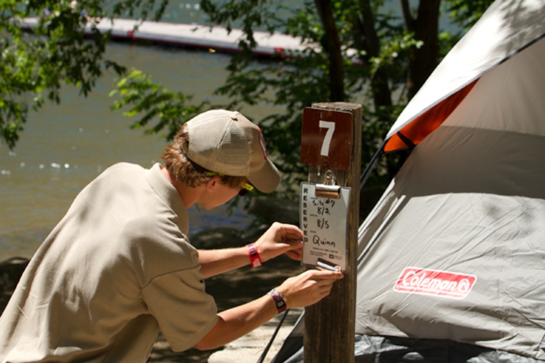 A volunteer posts a recreation.gov camping reservation at Macks Creek Park.