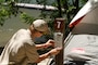 A volunteer posts a recreation.gov camping reservation at Macks Creek Park.