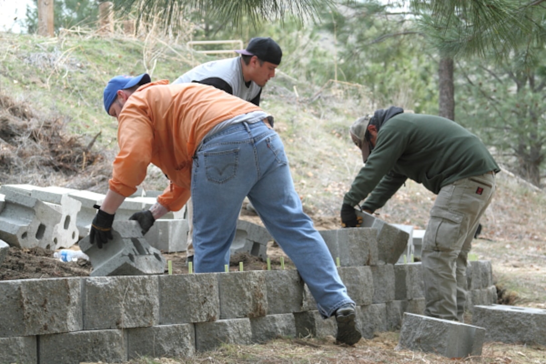 Volunteers construct a retaining wall for a tent site at Macks Creek Park, Lucky Peak Lake.