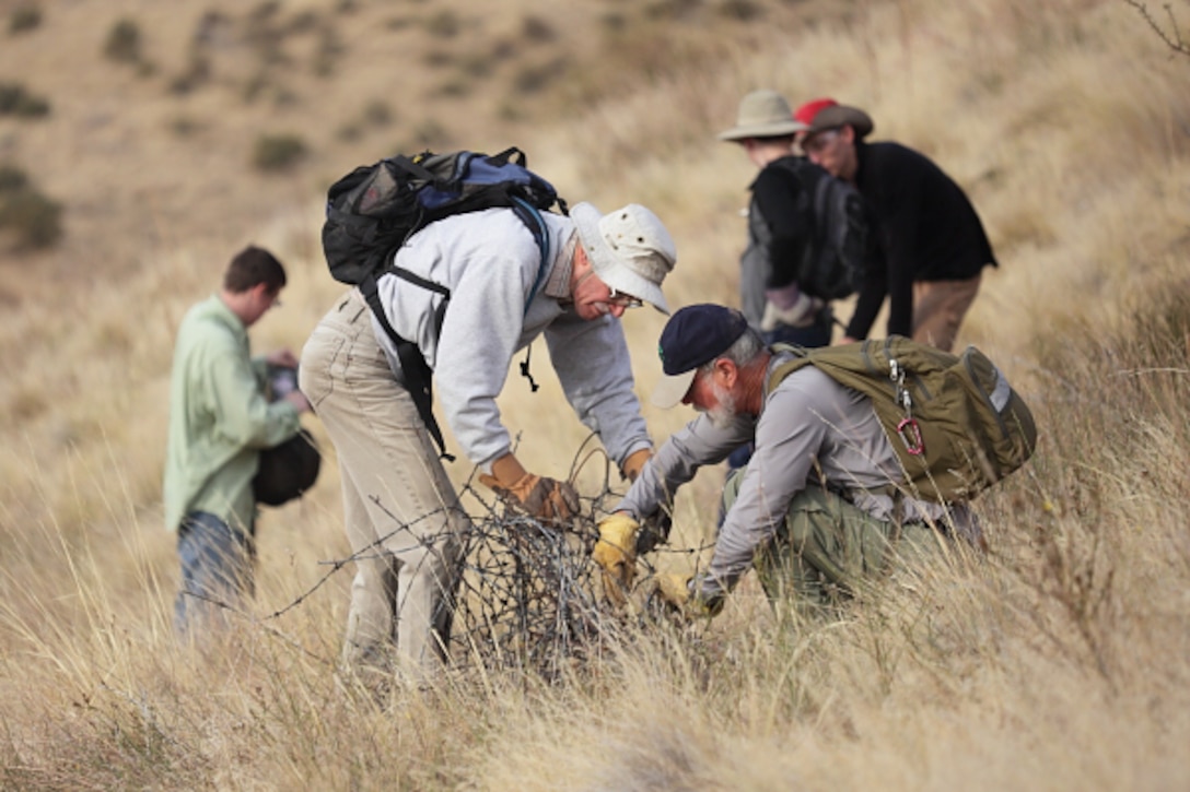 Volunteers removing abandoned barbed-wire fencing from Lucky Peak Lake.