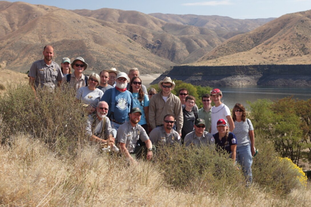 A group of National Public Lands Day volunteers and Corps staff enjoying their accomplishment of removing one mile of abandoned barbed-wire fence at Lucky Peak Lake.