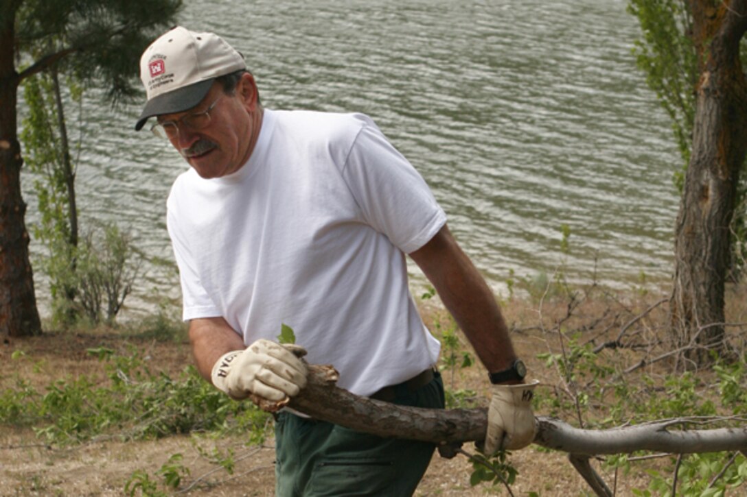 A volunteer trims and hauls tree limbs at Macks Creek Park, Lucky Peak Lake.