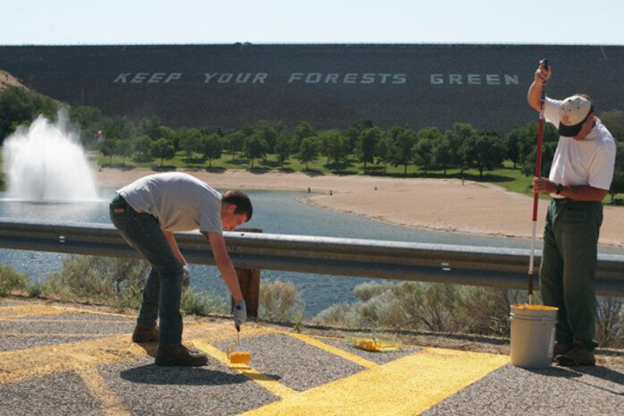 Volunteers refresh road paint on Lucky Peak Lake’s entrance road.