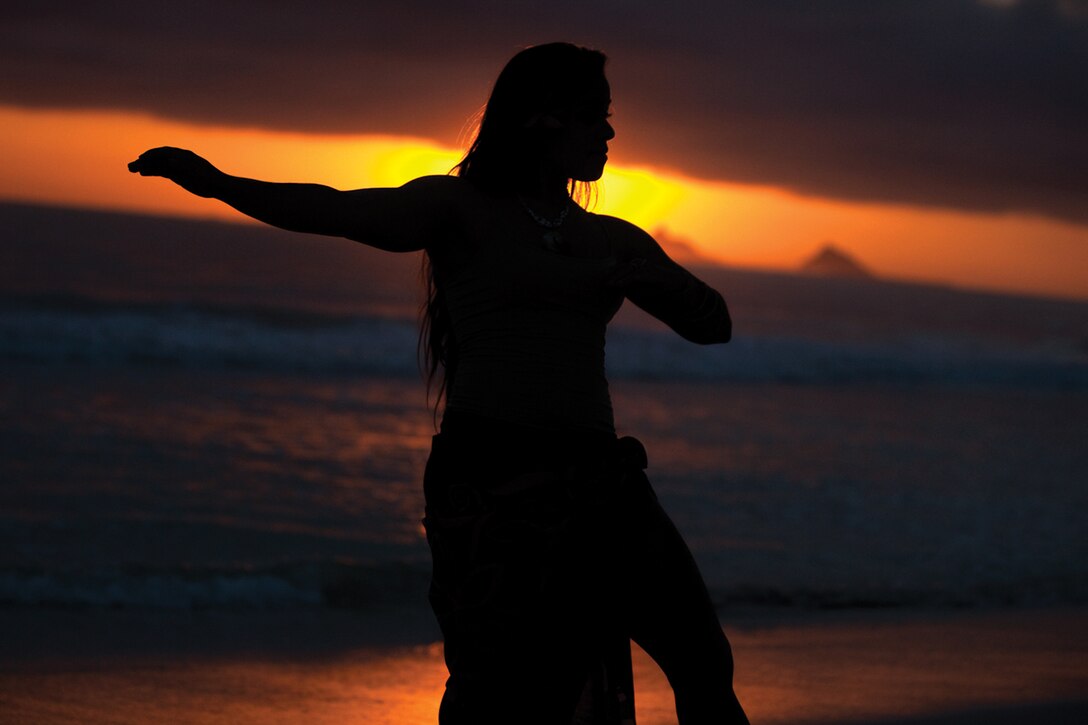 Kristi De Lashmutt, a musician with U.S. Marine Corps Forces, Pacific Band, demonstrates Polynesian dance at Kailua Beach in Kailua, Hawaii, Jan. 11, 2014. De Lashmutt has been involved in Polynesian dancing since she was 13 years old. (U.S. Marine Corps photo by Cpl. Sarah Dietz)