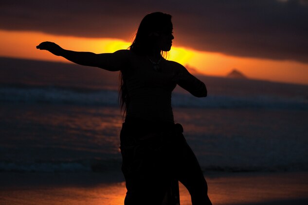 Kristi De Lashmutt, a musician with U.S. Marine Corps Forces, Pacific Band, demonstrates Polynesian dance at Kailua Beach in Kailua, Hawaii, Jan. 11, 2014. De Lashmutt has been involved in Polynesian dancing since she was 13 years old. (U.S. Marine Corps photo by Cpl. Sarah Dietz)