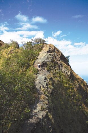 Nathan Knapke, a combat correspondent with the public affairs office, hikes up to a peak on the ridge between Kuliouou Ridge and Puu O Kona, Jan. 12, 2014. (U.S. Marine Corps photo by Lance Cpl. Matthew J. Bragg)