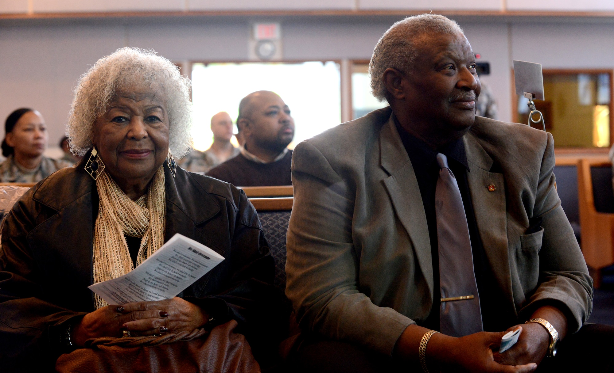 Joe McNeil, former mayor of Mountain Home, Idaho, and his wife Mildred listen to speakers during the Rev Dr. Martin Luther King Jr. birthday observance, Jan. 17, 2013 at Mountain Home Air Force Base, Idaho. Col. Christopher Short, 366th Fighter Wing commander, shared his views on King and how we could carry on his legacy. (U.S. Air Force photo by Airman 1st Class Malissa Lott/Released)