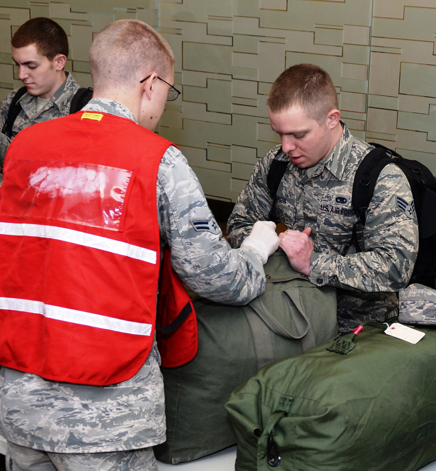 Airmen process through a mobility line where their bags are inspected prior to boarding an aircraft at Ellsworth Air Force Base, S.D., Jan. 17, 2014. Aircrews, maintenance, and support personnel from Ellsworth will execute B-1 bomber missions designed to provide multi-role airpower in support of U.S. and coalition forces. (U.S. Air Force photo by Airman 1st Class Rebecca Imwalle/Released)