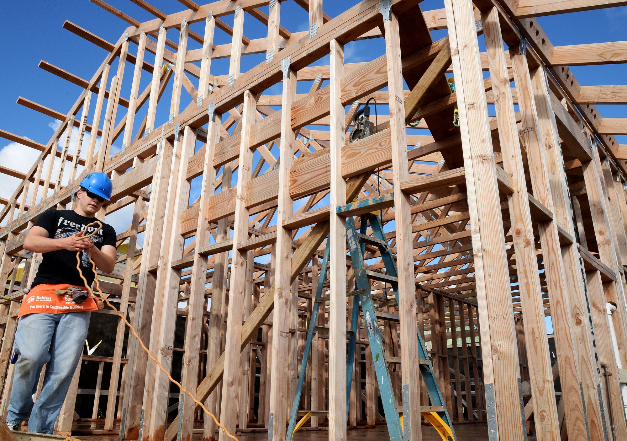 1st Lt. James Griffin, 15th Comptroller Squadron financial service officer, cleans up a worksite while volunteering with a group of Airmen at a Honolulu Habitat for Humanity project in Waimanalo, Hawaii, Jan. 15, 2014. The 15th CPTS Airmen spent the day assisting construction professionals and other volunteers with building homes for families in need. (U.S. Air Force photo/Staff Sgt. Alexander Martinez)
