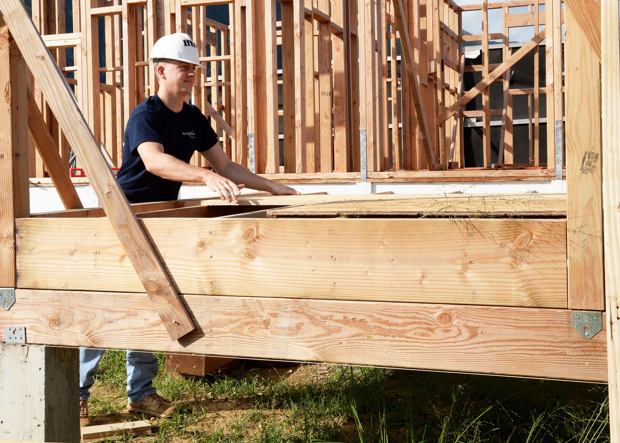 Airman 1st Class Aron Wing, lays a panel of wood while volunteering with a group of Airmen from the 15th Comptroller Squadron at a Honolulu Habitat for Humanity project in Waimanalo, Hawaii, Jan. 15, 2014. The Airmen spent the day assisting construction professionals and other volunteers with building homes for families in need. (U.S. Air Force photo/Staff Sgt. Alexander Martinez)