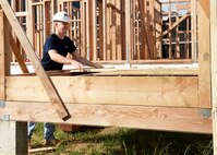 Airman 1st Class Aron Wing, lays a panel of wood while volunteering with a group of Airmen from the 15th Comptroller Squadron at a Honolulu Habitat for Humanity project in Waimanalo, Hawaii, Jan. 15, 2014. The Airmen spent the day assisting construction professionals and other volunteers with building homes for families in need. (U.S. Air Force photo/Staff Sgt. Alexander Martinez)