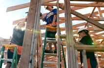 From left: Staff Sgt. Angela Parker, Maj. Amanda Evans, 15th Comptroller commander, and Staff Sgt. Nichole Rush, work on the wood frame of a house while volunteering with a group of Airmen at a Honolulu Habitat for Humanity project in Waimanalo, Hawaii, Jan. 15, 2014. The 15th CPTS Airmen spent the day assisting construction professionals and other volunteers with building homes for families in need. (U.S. Air Force photo/Staff Sgt. Alexander Martinez)