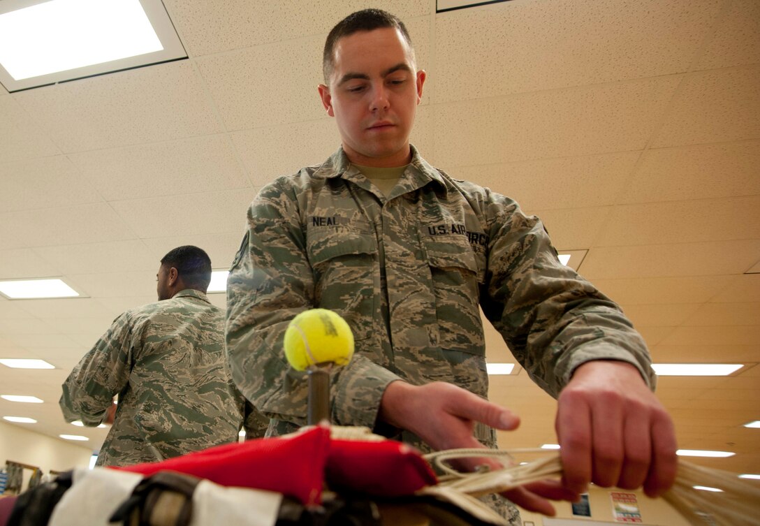 Airman 1st Class Andrew Neal, a 361st Training Squadron student, packs an ACES II recovery parachute in an ejection seat. The parachute is packed into the ejection seat to minimize space and allow full function for the pilot and aircraft. (U.S. Air Force photo by Airman 1st Class Jelani Gibson) 