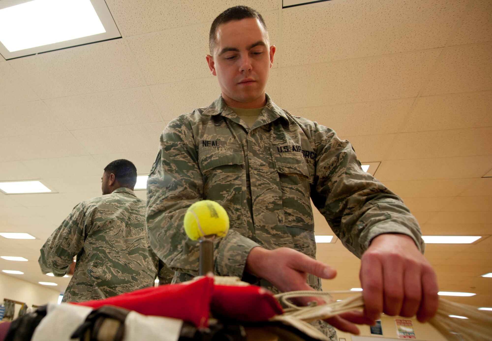 Airman 1st Class Andrew Neal, a 361st Training Squadron student, packs an ACES II recovery parachute in an ejection seat. The parachute is packed into the ejection seat to minimize space and allow full function for the pilot and aircraft. (U.S. Air Force photo by Airman 1st Class Jelani Gibson) 