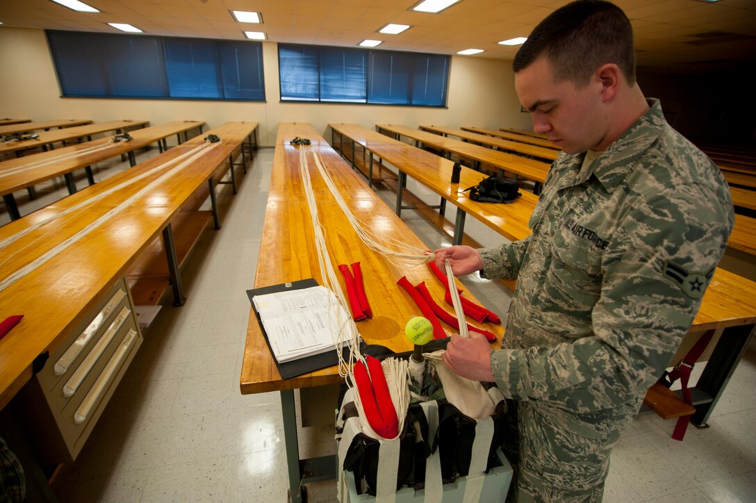 Airman 1st Class Andrew Neal, a 361st Training Squadron student, packs an ACES II recovery parachute in an ejection seat. The parachute is packed into the ejection seat to minimize space and allow full function for the pilot and aircraft. (U.S. Air Force photo by Airman 1st Class Jelani Gibson) 