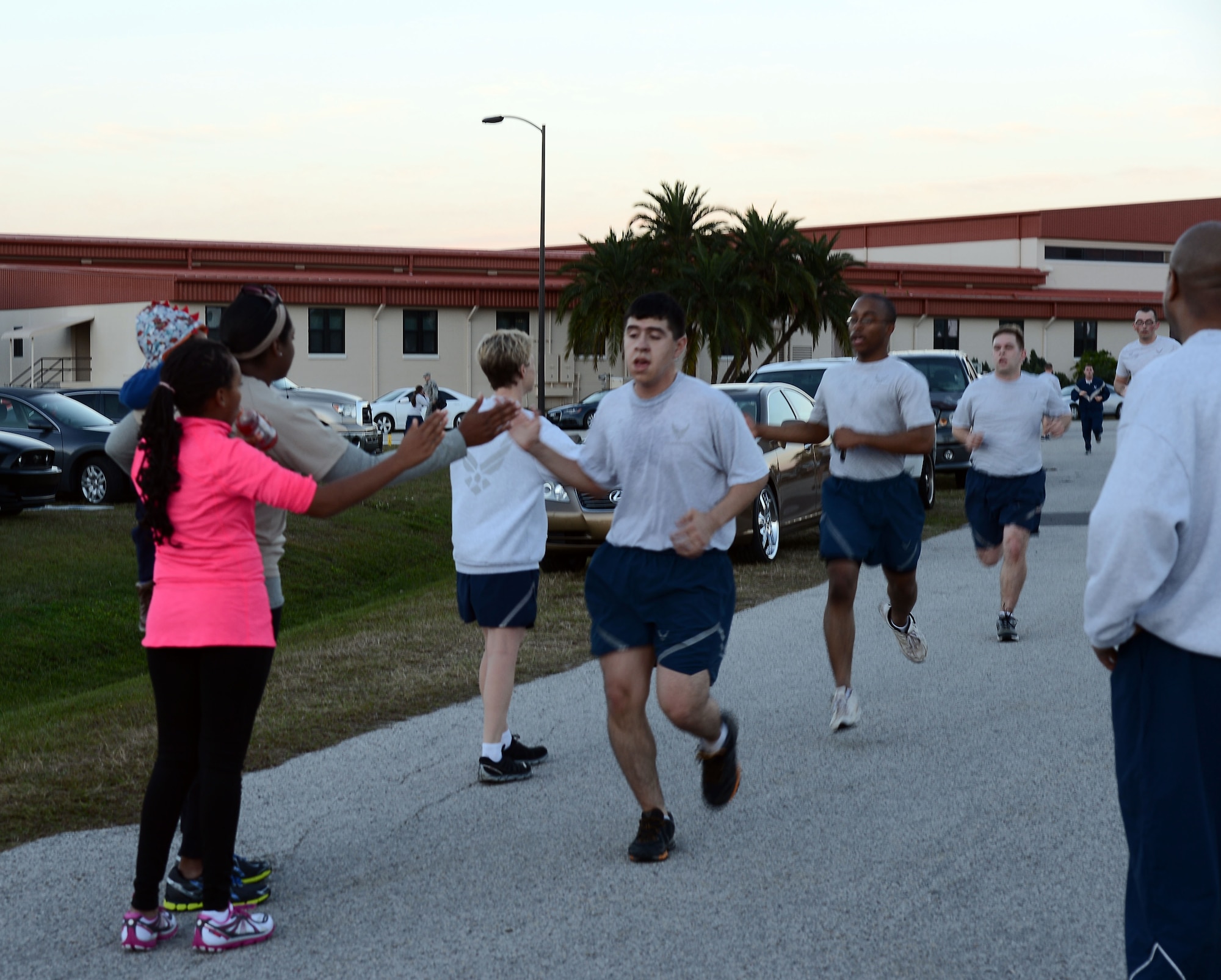 The Estelle family congratulates members of Team MacDill as they finish a 6K at MacDill Air Force Base Fla., Jan. 15, 2014.  During the first annual commemoration of the fallen hero, Maj. Raymond Estelle II, the 6th CS held a 6K run and a weight lifting competition. (U.S Air Force photo by Airman 1st Class Tori Schultz/Released)