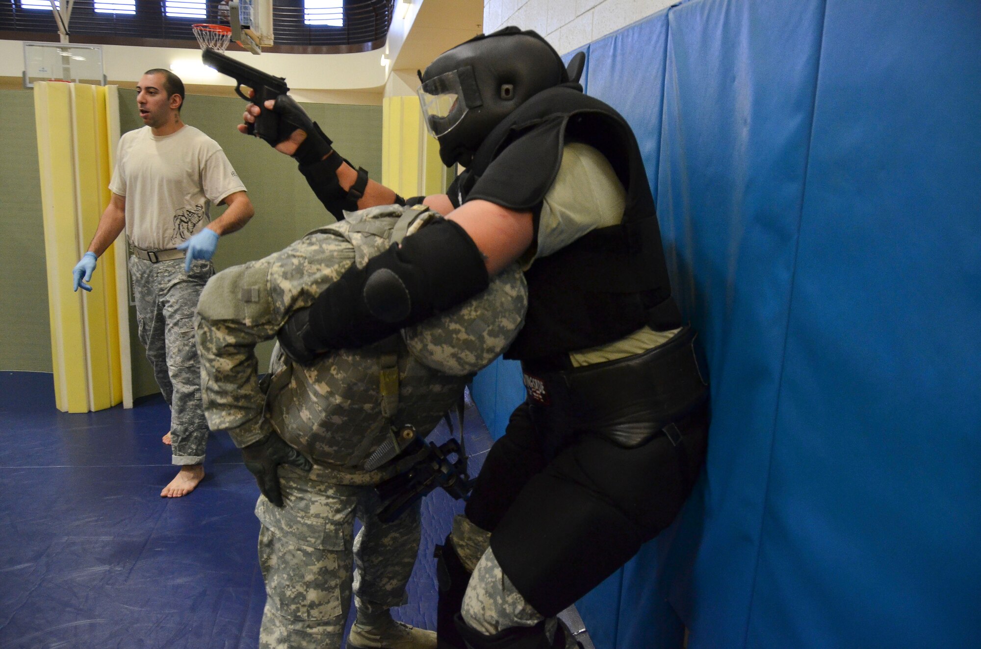 A combatant takes the weapon from a student during the room clearing portion of the Modern Army Combatives Program (MACP) Basic Combatives Course Level 1 at Davis-Monthan Air Force Base, Ariz., Jan. 16, 2014. The 40-hour course focuses on the three phases of basic fighting strategy; close the distance, gain the dominate position, and how to finish the fight. (U.S. Air Force photo by Staff Sgt. Adam Grant/Released)