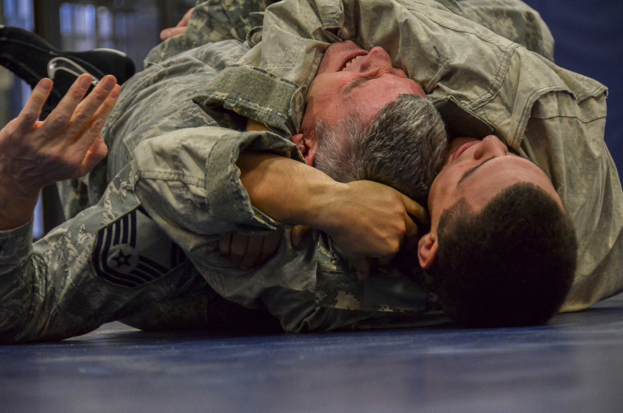 Airman 1st Class Greg Vinueza, attempts to subdue Senior Master Sgt. Kevin Wendt, 612th Support Squadron, during the last man standing drill portion of the Modern Army Combatives Program (MACP) Basic Combatives Course Level 1 at Davis-Monthan Air Force Base, Ariz., Jan. 16, 2014. The 40-hour course focuses on the three phases of basic fighting strategy; close the distance, gain the dominate position, and how to finish the fight. (U.S. Air Force photo by Staff Sgt. Adam Grant/Released)