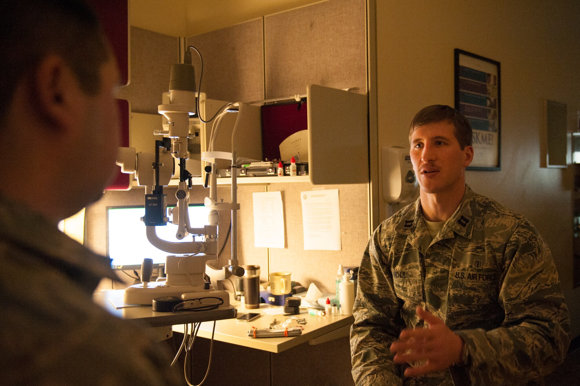 Captain Eric Noll, 5th Medical Operations Squadron optometrist, talks to a patient at Minot Air Force Base’s optometry office, Jan. 14, 2014. Noll, who arrived in August, is now offering full-service eye care at the optometry office. (U.S. Air Force photo/Airman 1st Class Apryl Hall)